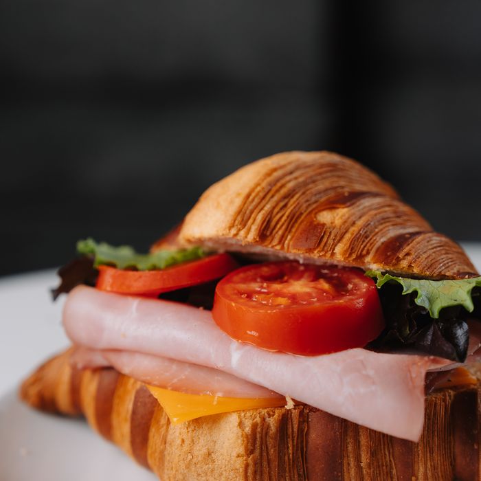 Ham and cheese croissant sandwich with tomato